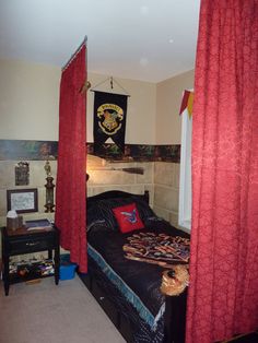 a bedroom with red curtains and a black bed in it's centerpieces