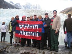 a group of people standing next to each other holding a flag