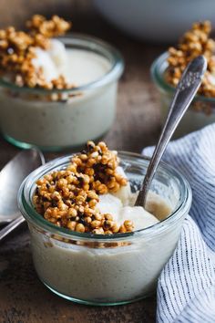 two small bowls filled with food on top of a wooden table