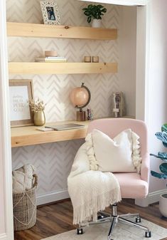 a pink chair sitting in front of a wooden shelf