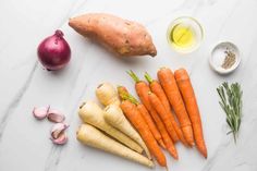 carrots, garlic, and other vegetables on a table