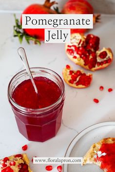 pomegranate jelly in a glass jar next to some fruit