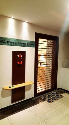 an empty room with wooden shutters on the door and shelves in front of it