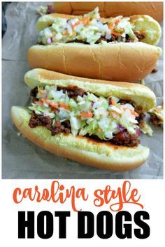 three hot dogs on buns with coleslaw and chili