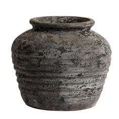 a large gray vase sitting on top of a white surface