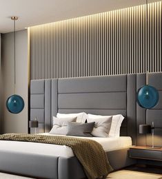 a bedroom with a large bed and two lamps on the wall above it's headboard