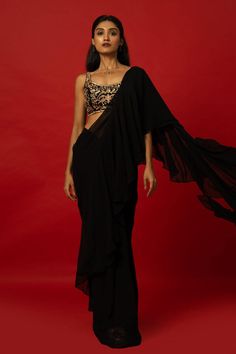 This elegant Black Ruffle Saree features a unique hand-embroidered stitched blouse for a one-of-a-kind look. The carefully crafted details add a touch of sophistication and style to any occasion. Perfect for those looking to make a statement with their traditional attire. Black Ruffle Saree, Embroidered Saree Blouse, Baluchari Saree, Golden Blouse, Saree Blouse Styles, Silver Blouse, Net Blouses, Cotton Gowns, Ruffle Saree