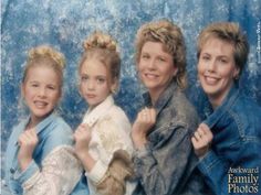 three women and a child posing for a photo together in front of a blue background