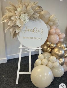 a sign with balloons and flowers on it in front of a birthday party backdrop that reads, fakie's 60th birthday