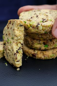 a person is holding some cookies in their hand and they are stacked on top of each other