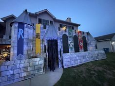 a house decorated for halloween with fake snowboards on the front wall and decorations around it