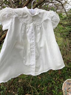 1960s Sorbeau white cotton infant dress: This little dress looks to be a 3-6 mo. in size. It is collared with lace trimmed puff sleeves. It also has dainty white floral embroidery and an organdy floral ribbon front. The hem is scalloped and lace trimmed. It includes a matching bonnet. Measurements: Across shoulders 8 in. Length 17 in. White Baby Dress, White Floral Embroidery, Inspired Clothes, Dress With Lace Trim, Floral Ribbon, Dress With Lace, White Outfits, Puff Sleeves, Floral Embroidery