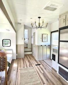 the inside of a home with wood floors and white walls