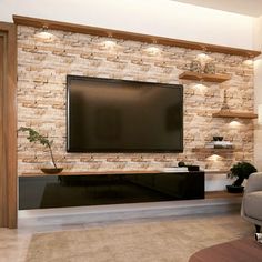 a living room with a large television mounted on the wall