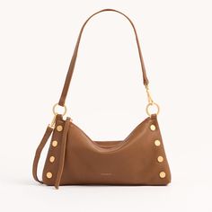 This fresh, of-the-moment bag is entering the chat as a must-have companion for nights on the town. Featuring a slouchy but current shape, this versatile little number transitions from a wristlet to a shoulder bag in seconds flat. The Kyle also includes a removable and adjustable crossbody strap, so you can go hands-free. A cousin of our best-selling mahogany suede collection, this leather features a soft pebbled texture with a hint of shine. Embrace the warm allure of this medium brown hue, enr Mini Jumpsuit, Fashion Forecasting, Black Pebbles, Valentine's Day Outfit, Red Suede, My Wish List, Medium Brown, Black Handbags, Accessories Bracelets