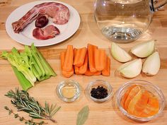 various vegetables and meats on a wooden table