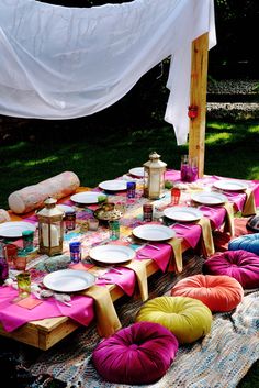 a table set up for a party with plates and napkins laid out on it