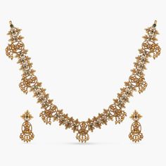 Product Description A blend of modern luxury and elegance. This antique necklace set will make all your special occasions a little more special. Our designers at Tarinika crafted this beautiful minimal looking temple necklace to meet your everyday needs. It features Goddess Lakshmi and floral motifs, studded with high quality CZ stones and gold beads droplets. A tasteful and elegant necklace that goes well with all Indian attire. Details & Specifications: Materials used: CZ stones with Antique P Antique Necklace Set, Gold Earrings For Kids, Temple Necklace, Gold Bridal Jewellery Sets, Buy Jewellery Online, Jewelry Sale, Goddess Lakshmi, Elegant Necklace, Gold Necklace Designs