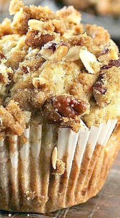 a muffin with crumbs and nuts on top