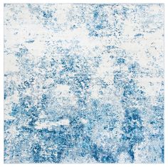 an abstract blue and white rug with lots of paint on it's surface in the middle