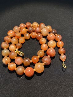 The orange color carnelian beads from my collections of ancient beads. The origin of this beads from Tibet although the carnelian agate can be found in Pakistan India Nepal and Afghanistan as well small agate beads used as counter beads best gift for the people who collect ancient beads and best for the people who study ancient history we provide fast and free shipping to our customers by which you can get the item by 7 maximum working days Orange Gemstone Vintage Necklace, Orange Gemstone Vintage Necklaces, Hand-strung Orange Necklace, Vintage Orange Gemstone Necklaces, Single Strand Carnelian Necklace In Amber, Amber Carnelian Single Strand Necklace, Orange Single Strand Spiritual Necklace, Round Carnelian Gemstone Beads Necklace, Orange Carnelian Round Bead Jewelry