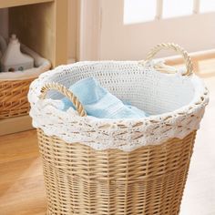 a wicker basket sitting on top of a hard wood floor next to a fire place