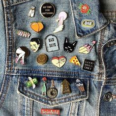 the back pocket of someone's jean jacket with many different pins on it,