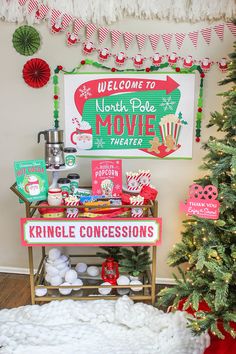 a christmas display in the corner of a room with a sign and decorations on it