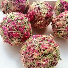 several balls of yarn covered in pink and green sprinkles on a white surface