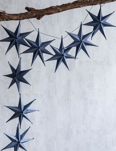 a bunch of blue stars hanging from a tree branch