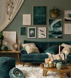 a living room filled with green furniture and pictures on the wall above it's coffee table