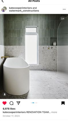 a white tub sitting inside of a bathroom next to a window