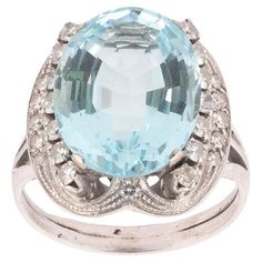 The oval-cut aquamarine approximately 8ct size 16mm x 12mm x 0,8mm , in a six-claw setting, within a contoured frame set with brilliant and single-cut diamonds, diamonds approx. 0.65ct total. Size : 8 Weight: 8.58gr. Diamond Dress Ring, Sapphire Cocktail Ring, Vestidos Retro, Vintage Cocktail Ring, Diamond Dress, Dress Ring, Claw Setting, Diamond Cocktail Rings, Aquamarine Rings