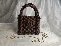 Handmade Brown Beaded Bag with Golden-Toned Hardware This elegant handbag, crafted from brown beads, features golden-toned hardware and a 47-inch removable chain. The magnetic closure adds convenience and ease of use. Our bags are 100% handmade. Each bag is unique and crafted with love for our customers. It takes 3-5 days to create one bag. A perfect gift for women, friend, family member or loved one. Ideal for any celebration, event, wedding or birthday party. This unique and distinctive bag wi Hand Beaded Bag, One Bag, Beaded Bags, Hand Beading, Clutch Handbag, Evening Bags, True Colors, Purses And Handbags, Gifts For Women