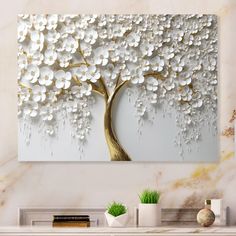 a large white tree with lots of white flowers on it's trunk in front of a marble wall