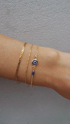 Before placing an order please check the estimated shipping times. If you need your order in a hurry shipping upgrades are available. Thank you. Brush away negative energy and jealous prying eyes with this dainty evil eye bracelet! D E T A I L S *It features a gold filled evil eye charm (12 x 6.5mm) in traditional blue *on a beautiful 18k gold filled chain. *Gold filled is a wonderful alternative to solid gold and unlike gold plating does not rub off. *A dainty sodalite gemstone adds a pretty de Minimalist Blue Bracelet With Delicate Chain, Evil Eye Bracelet For Everyday Wear, Minimalist Blue Evil Eye Bracelet For Everyday, Spiritual Evil Eye Bracelet For Everyday, Dainty Blue Evil Eye Bracelet, Minimalist Evil Eye Bracelet With Adjustable Chain, Dainty Evil Eye Bracelet With Adjustable Chain, Dainty Evil Eye Bracelet For Everyday Wear, Minimalist Gold Bracelets With Evil Eye