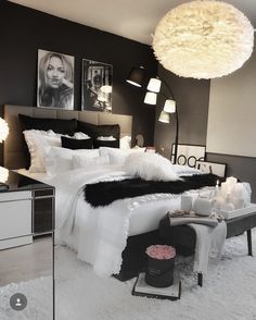 a bedroom with black walls and white fur on the bedspread is pictured in this image