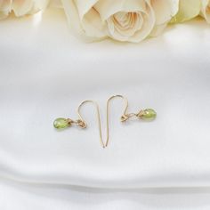 Feel the fresh touch of elegance with these peridot drop earrings! The gold peridot earrings add class and sophistication to all your outfits. Each faceted peridot shines and shimmer reflecting light when you turn your head. Peridot’s heart-centered energy empowers you to live your life with an openness to change and new experiences. The stone is genuine peridot in 14k gold-filled metal setting Teardrop peridots measure 0.28 inches tall by 0.20 inches wide (7mm tall by 5mm wide) You easily put e Elegant Lime Green Faceted Jewelry, Elegant Lime Green Earrings For Gift, Gold Peridot Earrings Fine Jewelry, Elegant Peridot Birthstone Earrings, Peridot Drop Earrings For May Birthstone, Elegant Peridot Dangle Earrings, Elegant Peridot Earrings With Ear Wire, Gold Peridot Earrings For May Birthstone, Elegant Peridot Earrings For May Birthstone