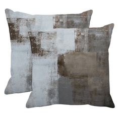 two gray and brown pillows on a white background