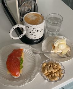 a table topped with plates and cups filled with food