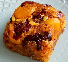 a close up of food on a plate with fruit and nuts in it, including rice