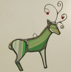 a stained glass reindeer ornament hanging from a ceiling