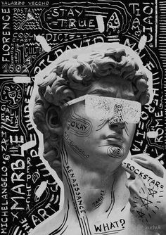 a black and white photo of a statue with writing all over it's face