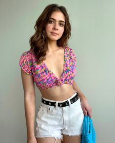 The Bogota Top is a beautifully-colorful crochet crop top with a cute flower appliqué and adjustable straps. A great top for beginners! Beginner friendly. The pattern is written in US crochet terminology. The printable PDF includes details of materials, abbreviations, gauge/sizing when applicable, and detailed instructions for crochet and assembly. PDF is in English only. Trendy Crochet Crop Top For Spring, Trendy Crochet Crop Top, Multicolor Cropped Crochet Top For Spring, Casual Multicolor Crochet Crop Top, Trendy Fitted Multicolor Crochet Top, Spring Pink Crochet Crop Top, Multicolor Cropped Crochet Top For Vacation, Casual Multicolor Crochet Lace Crop Top, Multicolor Crochet Summer Crop Top