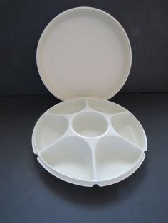 an empty white plate with six compartments on the bottom and four sections in the middle