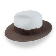 Description Materials Craftsmanship Hat Care Shipping Returns Product Description Elegant Two-Tone Panama Fedora: Where Straw Meets Felt Introducing the Monarch, a unique two-tone Panama fedora that blends the best of both worlds. This distinctive hat features a breathable Toquilla straw crown in off-white, beautifully contrasted with a taupe brown rabbit fur felt brim. The Monarch boasts a classic center-dent crown standing 5" tall and a generous 3" raw-edge snap brim, creating a silhouette tha Homburg Hat, Hats For Big Heads, Homburg, The Monarch, Crown Design, Formal Casual, Head Shapes, Hat Band, Fedora Hat