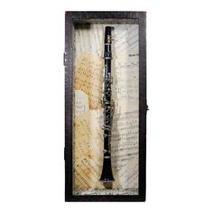 an old musical instrument with sheet music in it's shadow frame on a white background