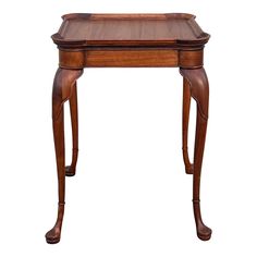 an antique wooden table with one drawer on the top and two legs at the bottom