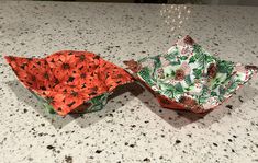 two paper bowls sitting on top of a counter