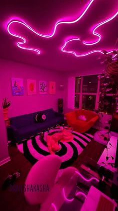 a living room filled with furniture and pink lighting on the ceiling above it is a spiral rug